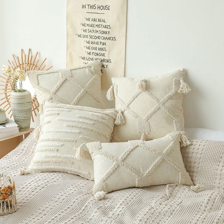 cream colored boho pillows on bed